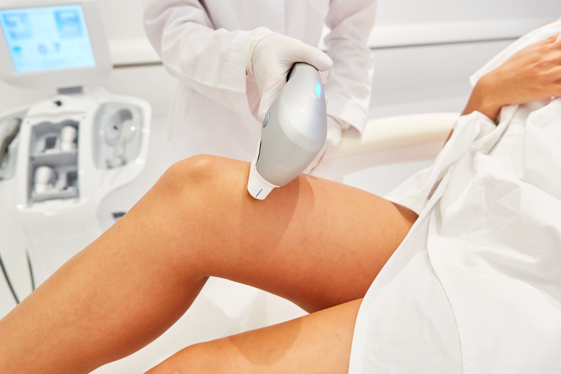 A professional applying dermatology services to a client.