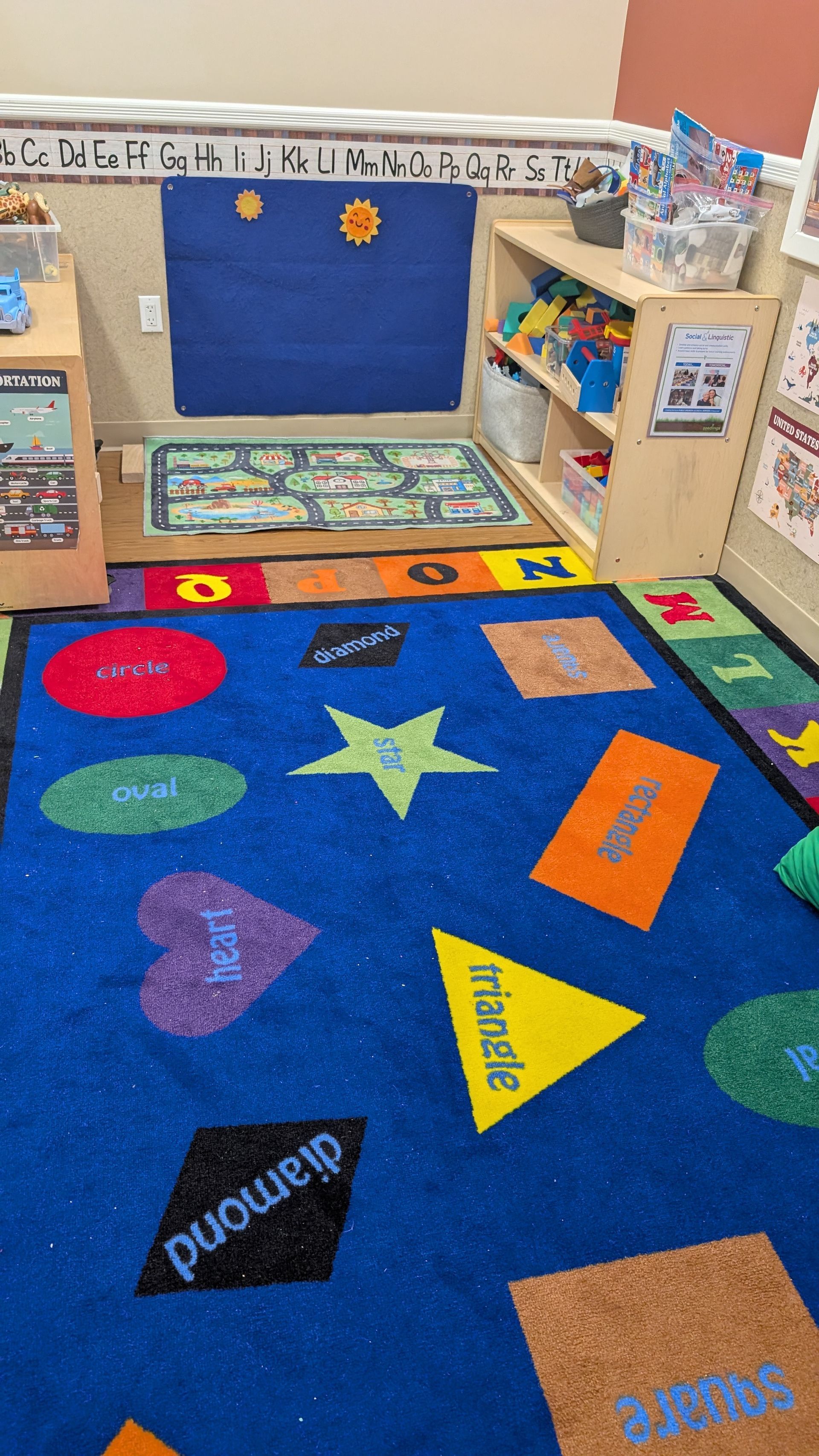 Colorful classroom rug after cleaning Colorful classroom rug with shapes and numbers in front of a bulletin board and toy shelves