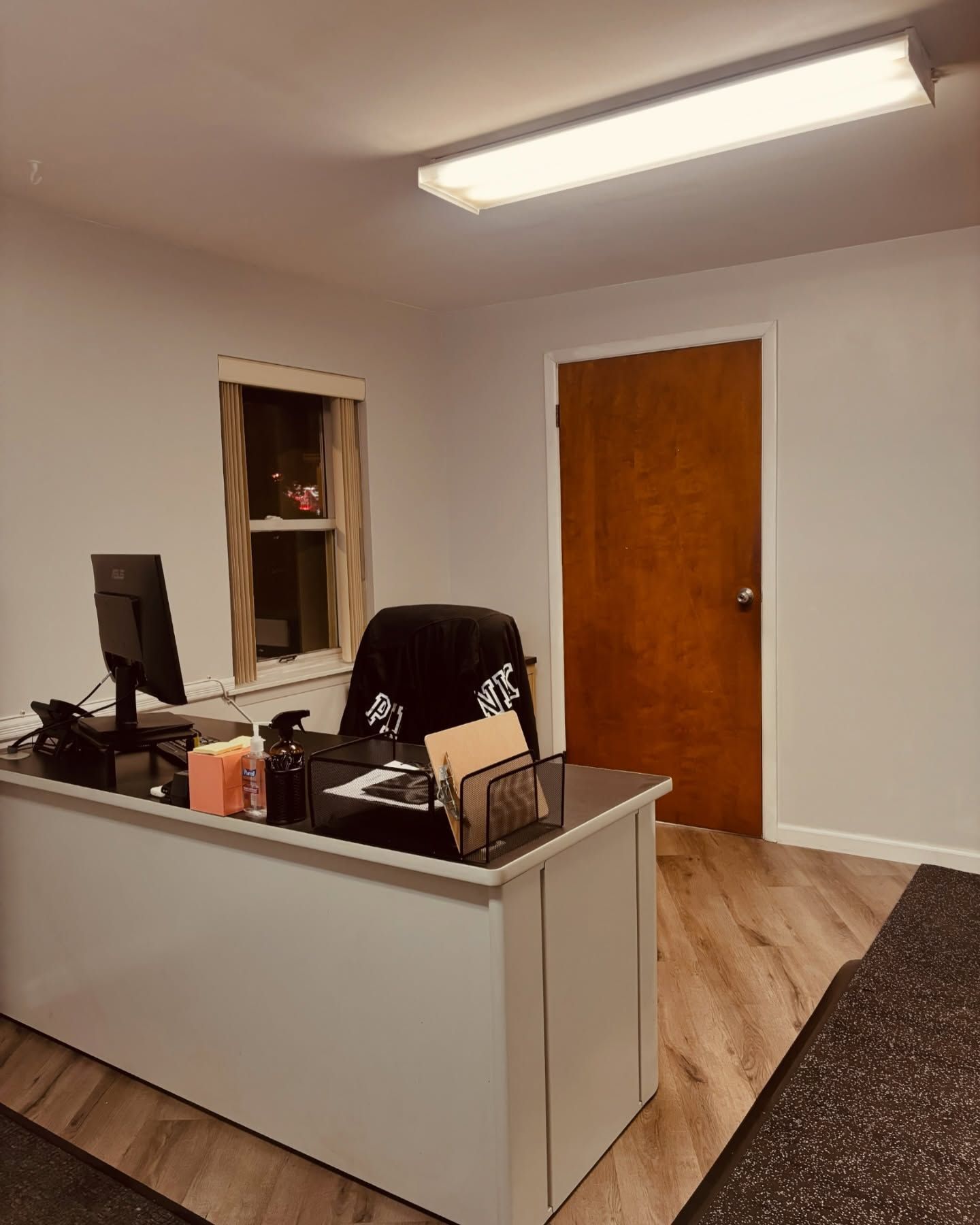 Dental clinic chair with overhead exam light in a bright, modern treatment room