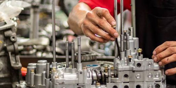 A man is working on a machine in a factory.