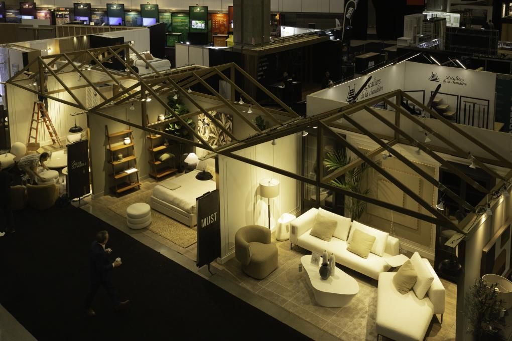 Showroom moderne avec espaces lounge ouverts, canapés blancs et éclairage d'ambiance chaleureux