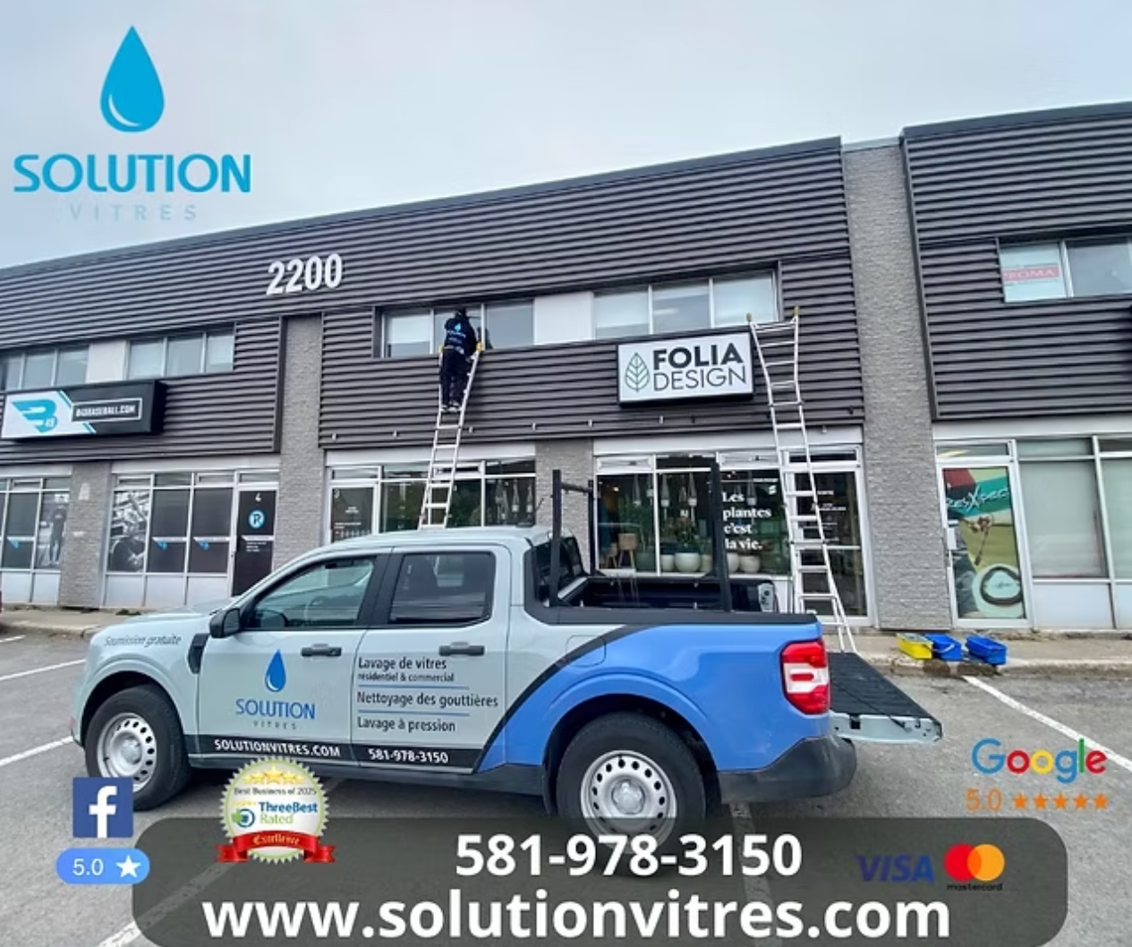 Un camion de Solution Services est stationné devant une vitrine portant l'enseigne « Folia Design » et le texte du site web.
