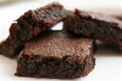 Brownies, chocolate, close-up view. Square slices, stacked.