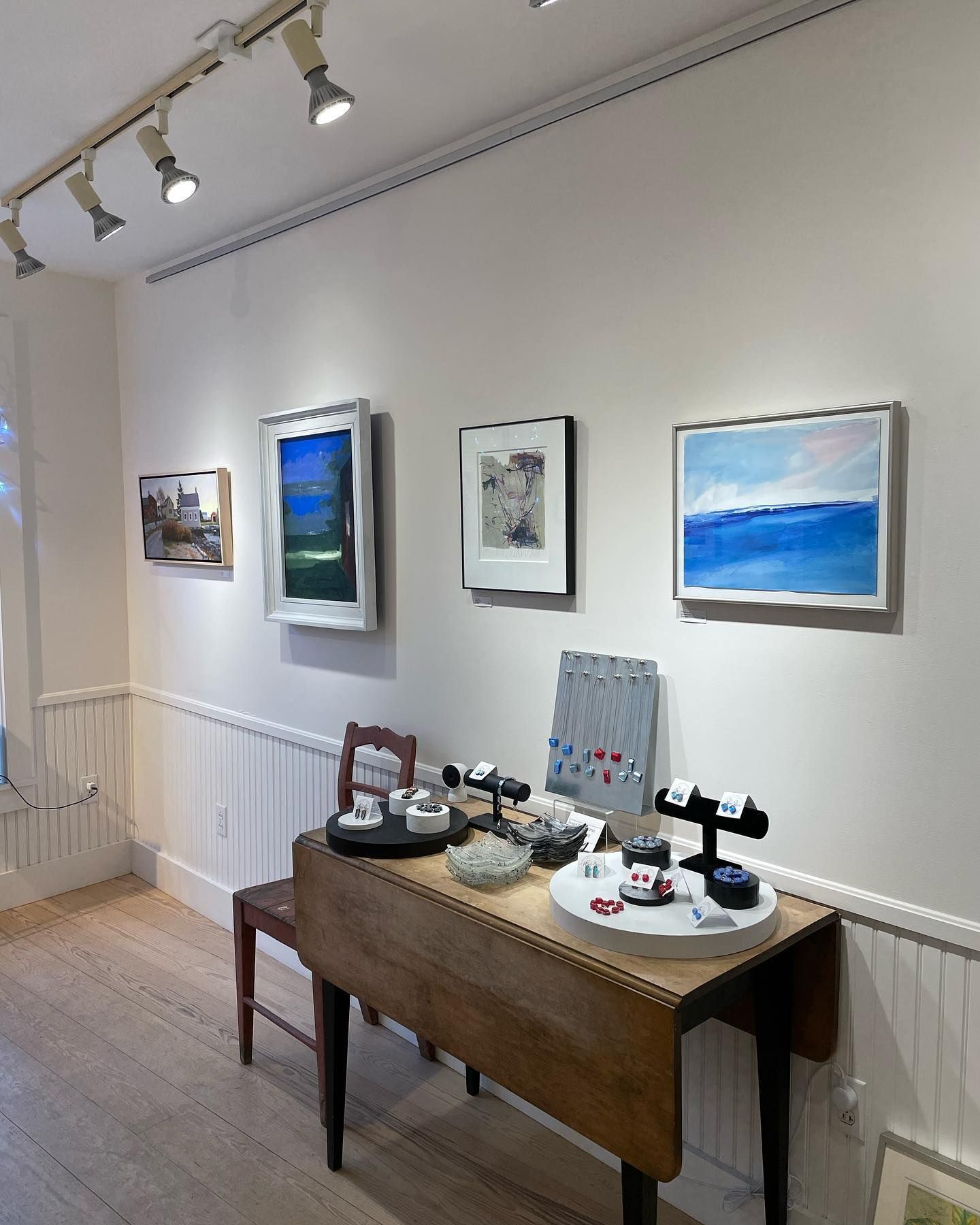 A room with a table and paintings on the wall