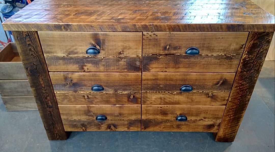 Rustic wooden dresser with six drawers and metal pulls, shown front view.