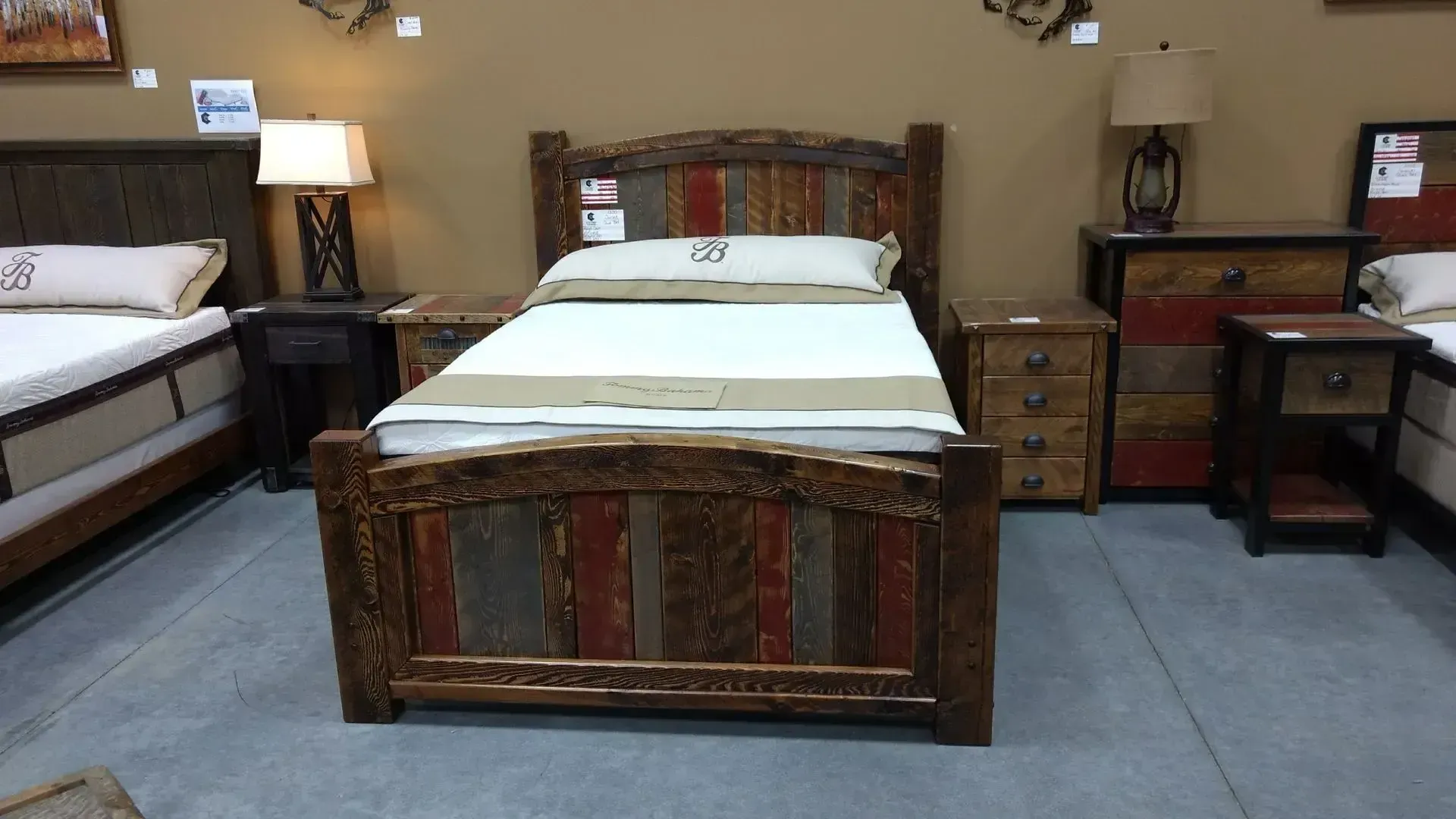Bedroom furniture showroom with two wooden beds, nightstands, and lamps on display