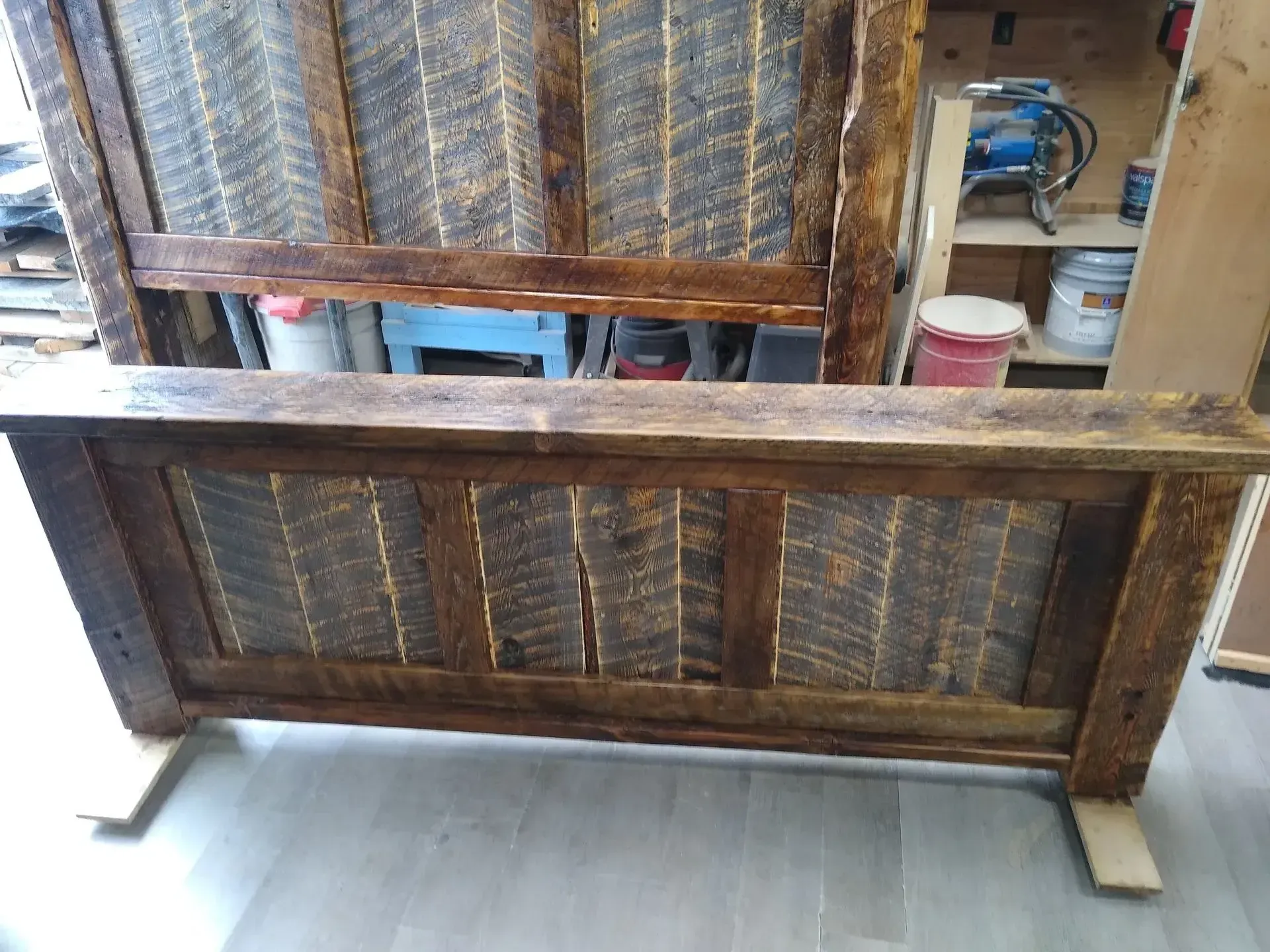 Wooden pallet-style frame standing on a concrete floor in a workshop or storage area