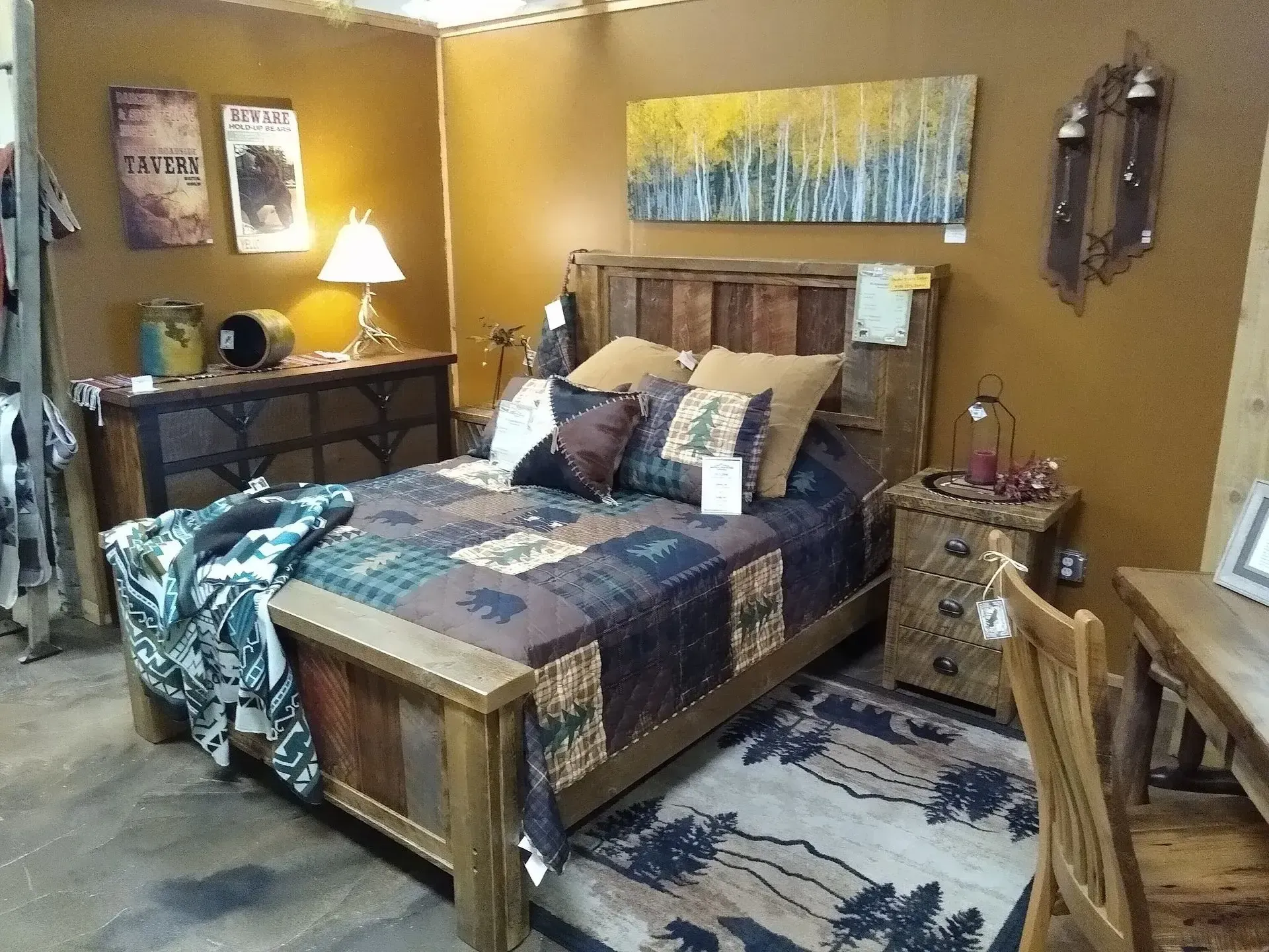 Cozy bedroom with a wooden bed, patchwork quilt, bedside lamps, and rustic decor in warm gold tones