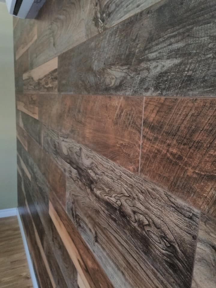 Vinyl or laminate flooring samples displaying different wood finishes.
