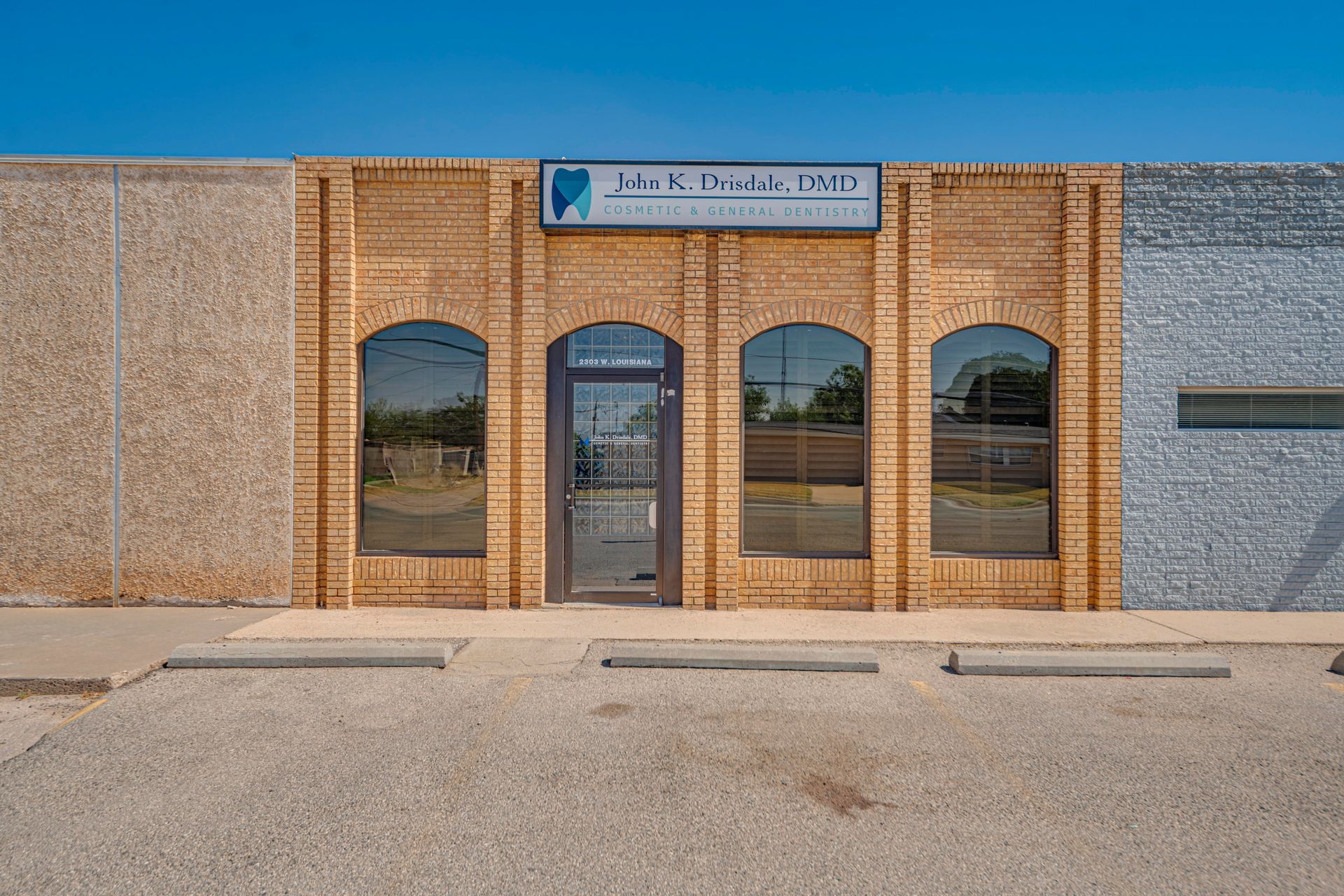 A brick building with a lot of windows and a sign on it.
