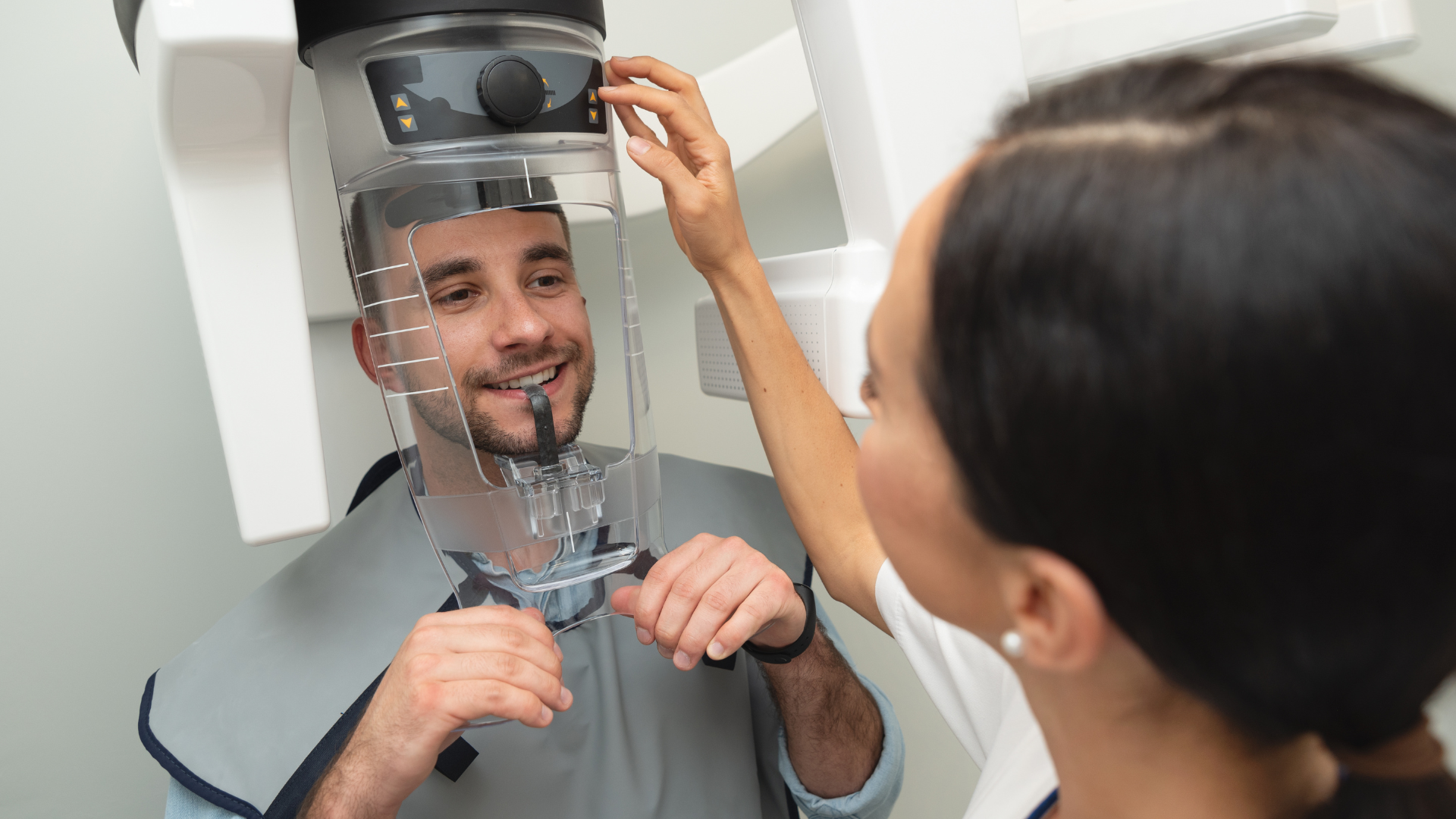 a woman is getting her teeth examined by a dentist in a dental office .