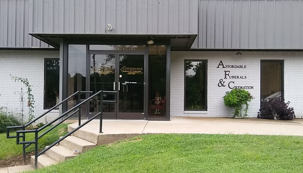 Building entrance with glass doors and sign for 