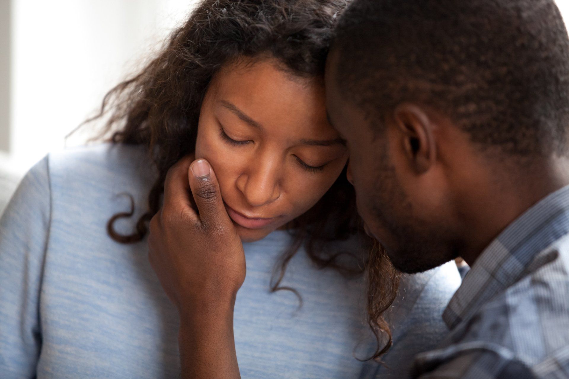 young woman is comforted by boyfriend