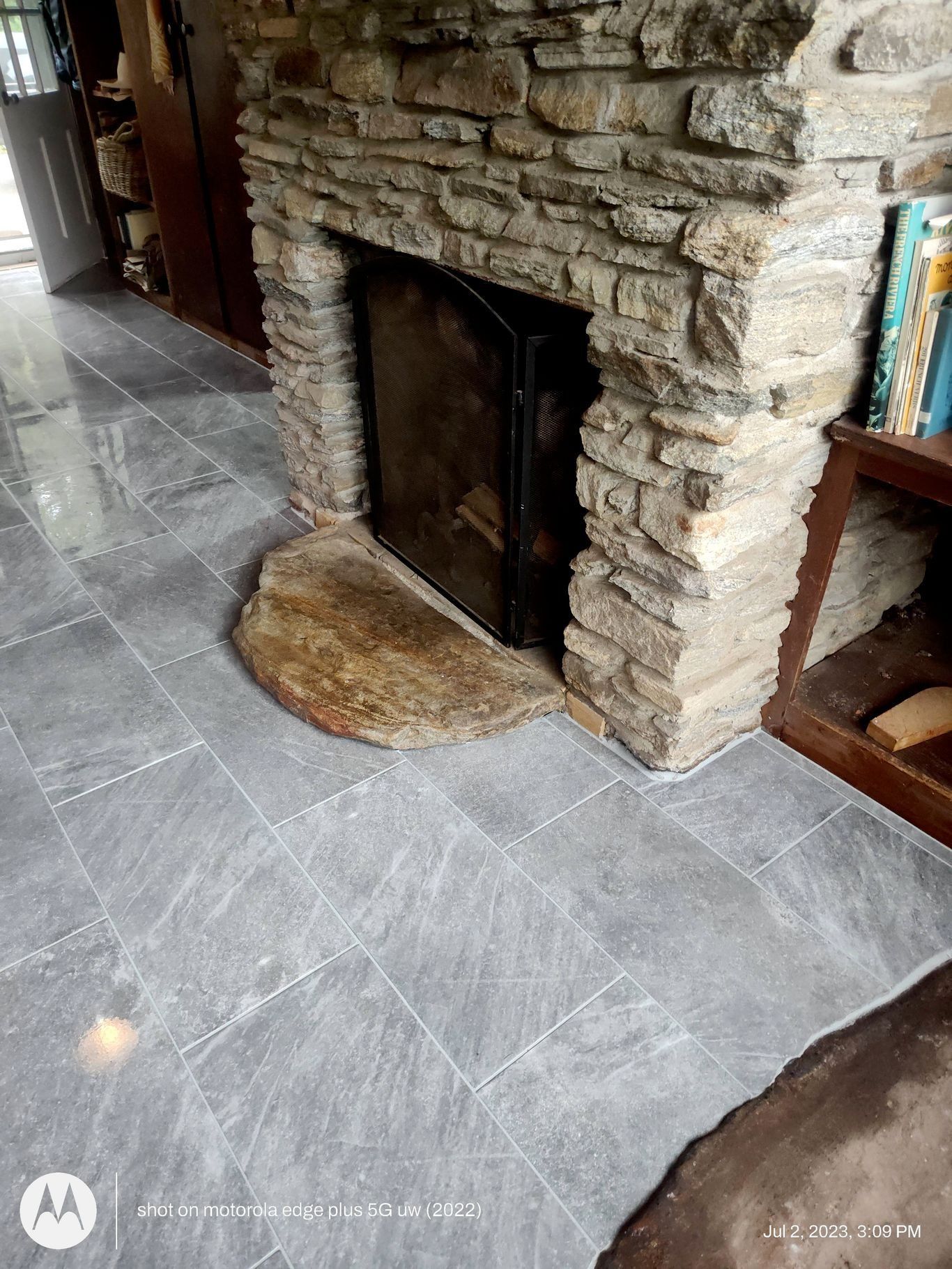 Light-colored wood flooring planks arranged in a classic, diagonal herringbone pattern.