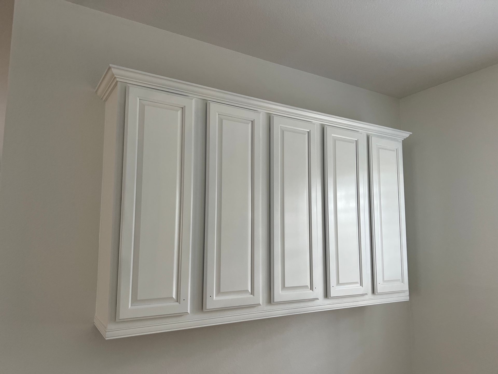 Transform your outdated cabinets by painting them with white semigloss finish 