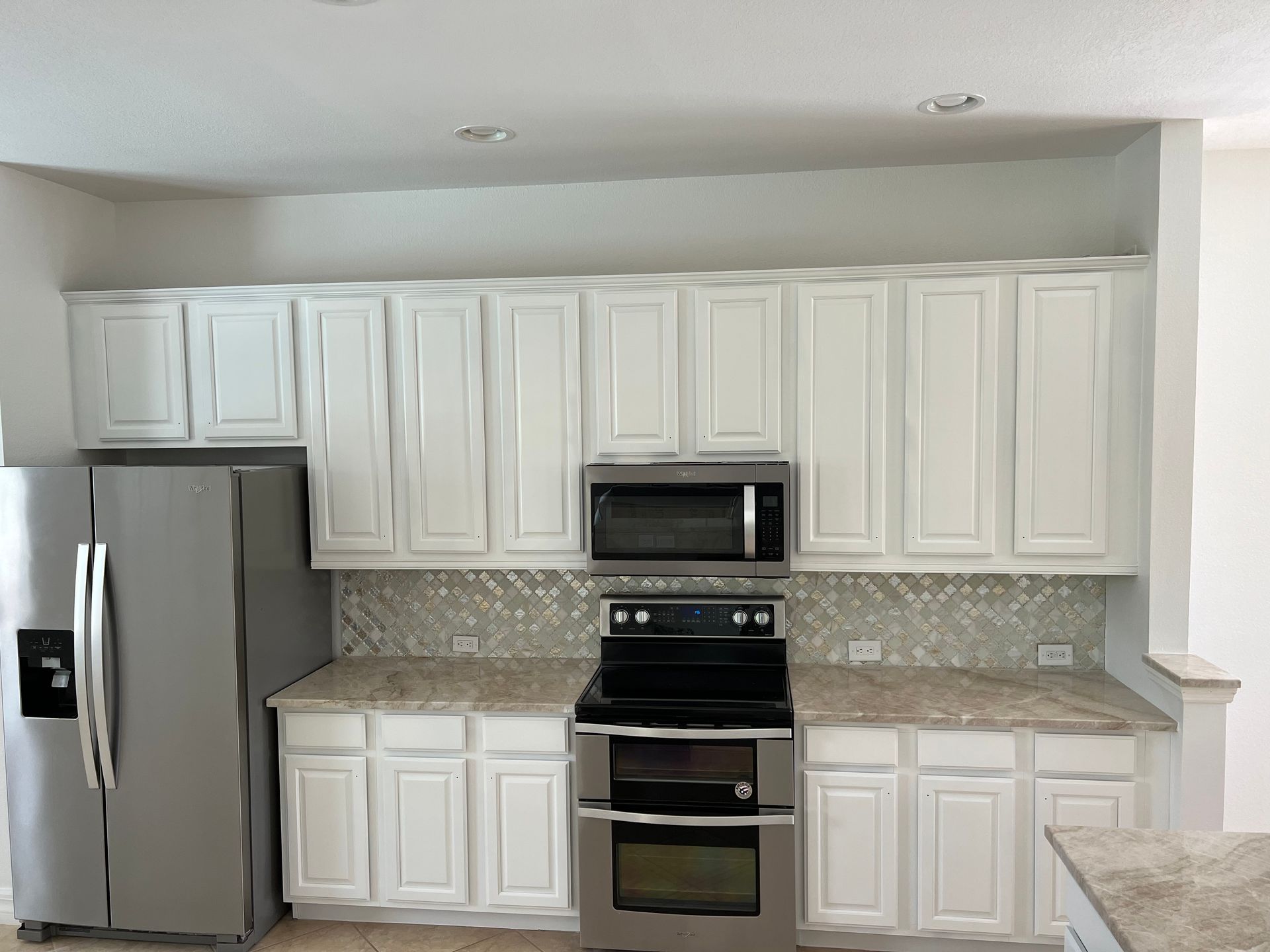 Transform your outdated cabinets by painting them with white semigloss finish