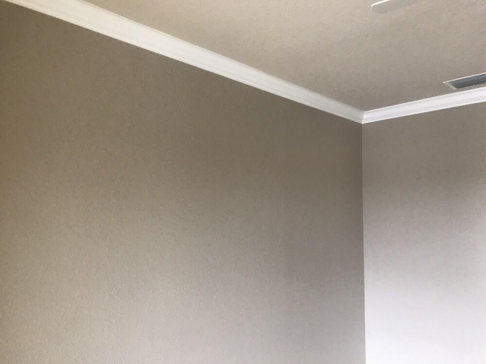There is a ceiling fan in the corner of the room.
