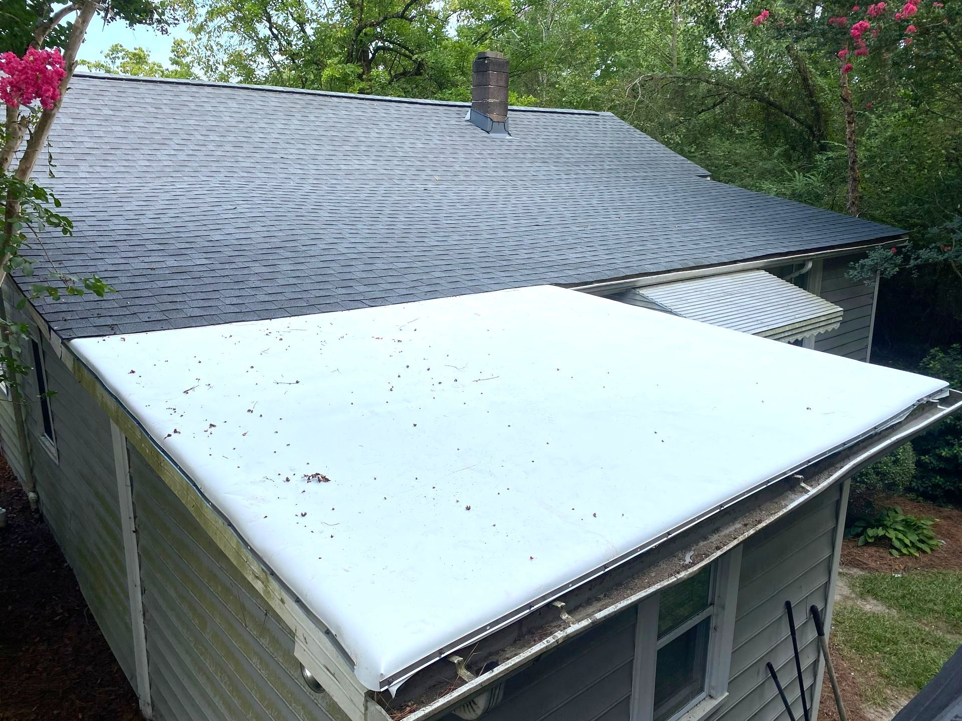 A house with a white roof and a black roof in Cary, NC.