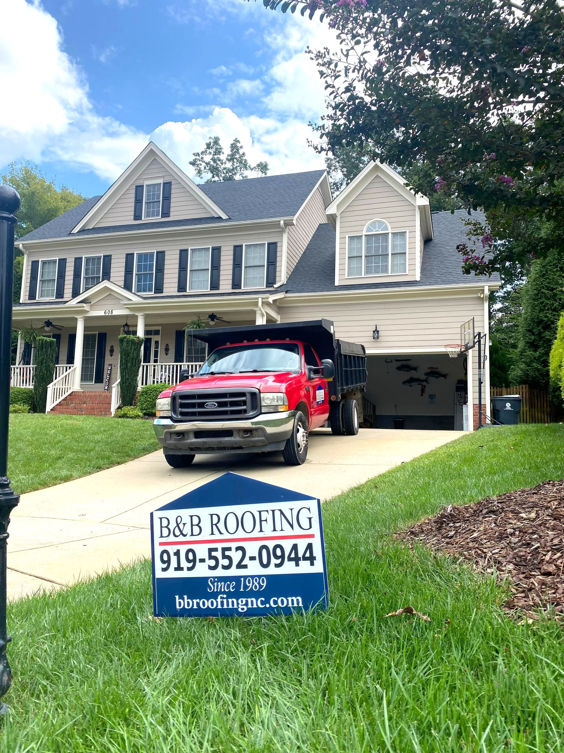 A red truck is parked in front of a large house in Apex, NC.