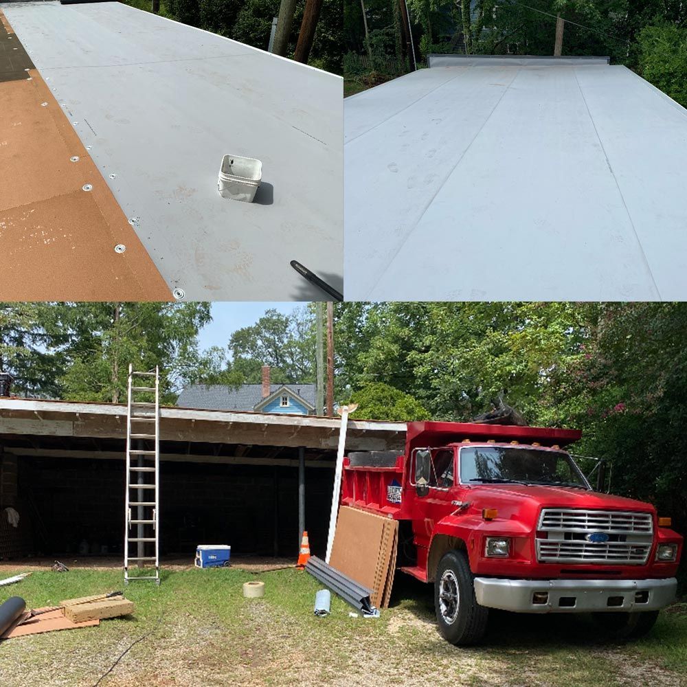 Flat roof with a new membrane installed, construction site with a red dump truck in Apex, NC.