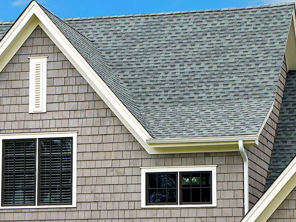 A house with a gray roof and white trim
