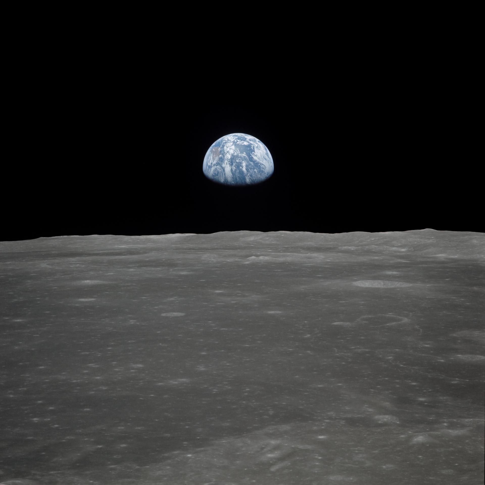 Earth rising over the lunar horizon, photographed from Apollo 11