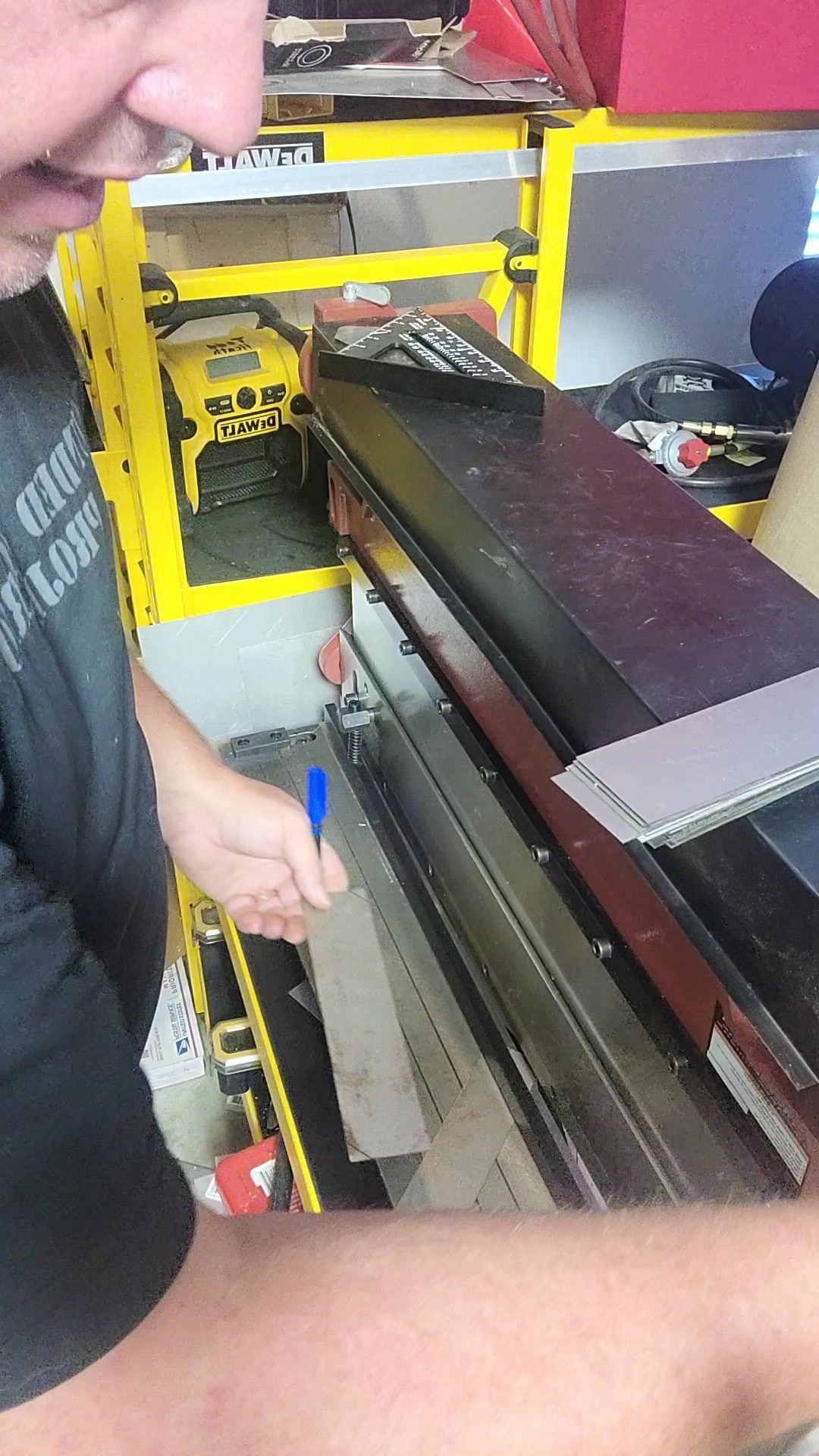 Hands working a steel part through the brake in the Hephaestus shop