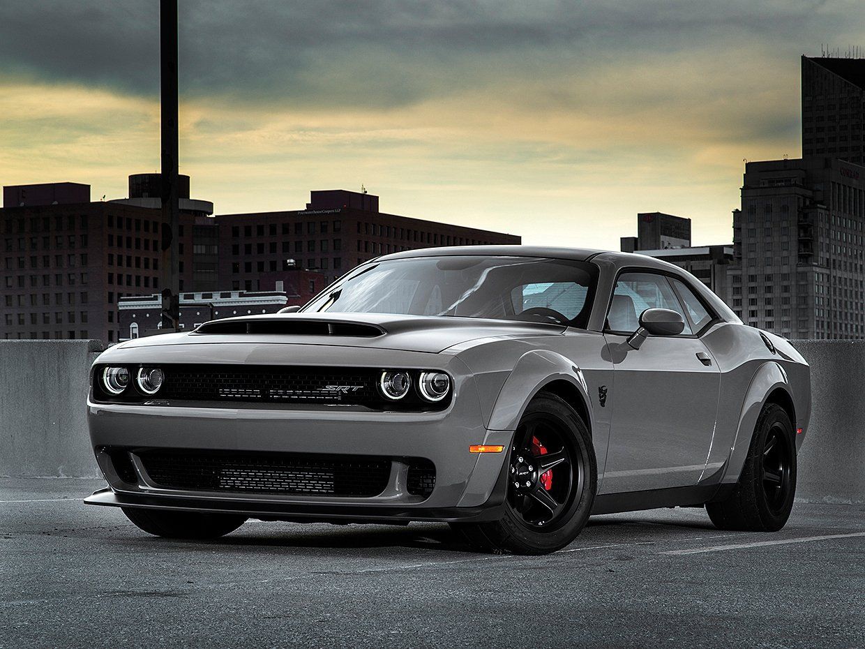 The Dodge Challenger is a muscle car that was first introduced in 1970. The Challenger Hellcat is a high-performance version of the Challenger that was introduced in 2015. It is powered by a supercharged 6.2L Hemi V8 engine that produces 707 hp and 650 lb⋅ft of torque. The Hellcat can accelerate from 0-60 mph in 3.6 seconds, and has a top speed of 199 mph. 