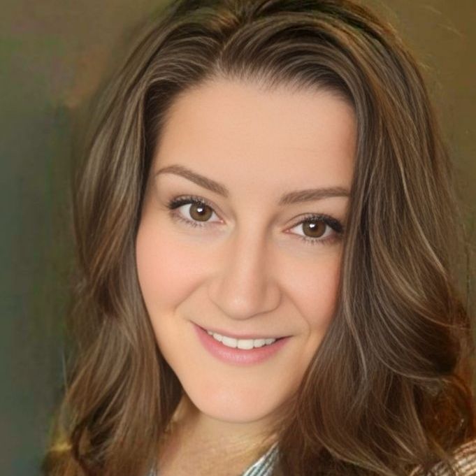 A woman with long brown hair is smiling for the camera