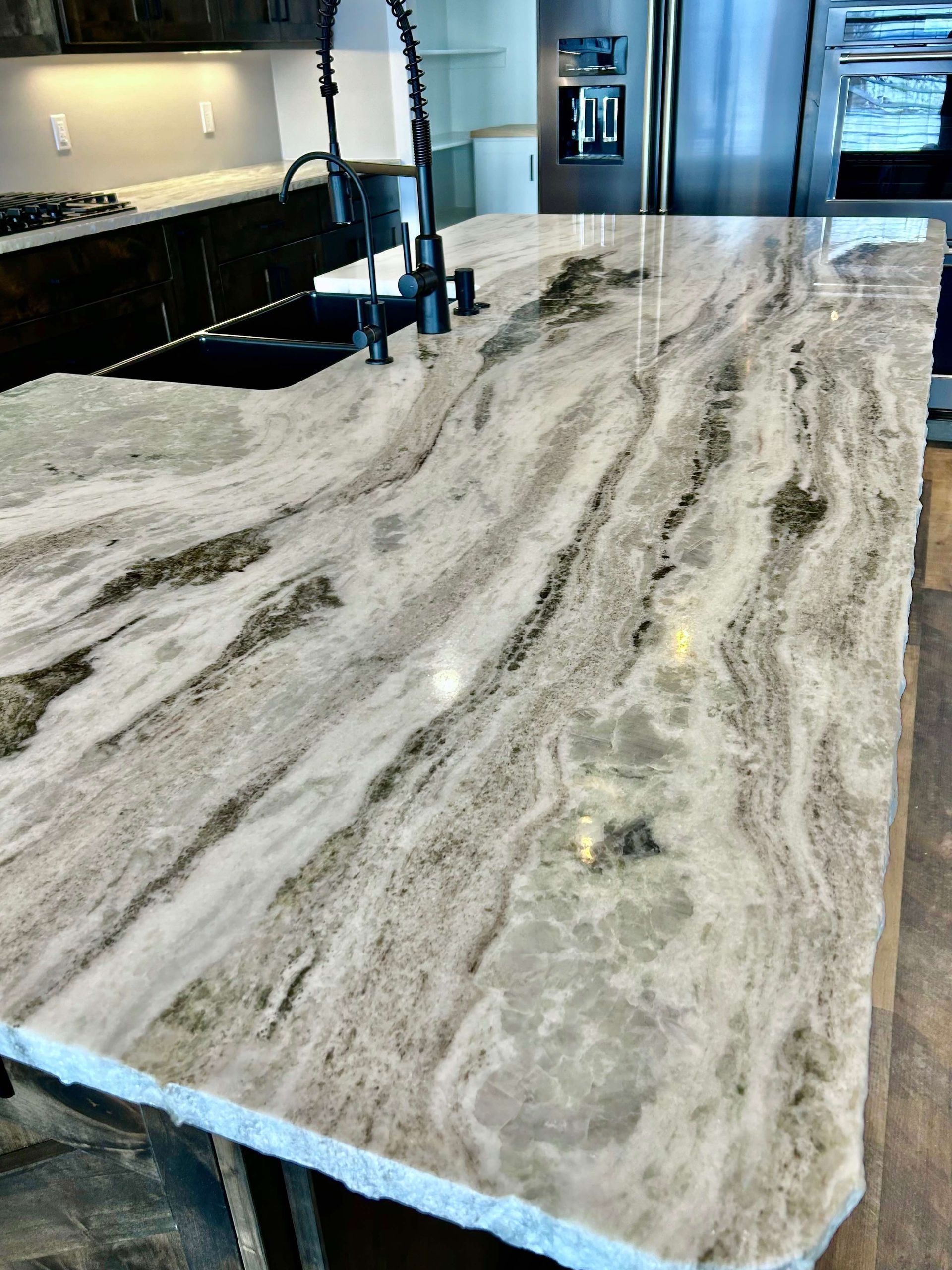 A kitchen with a large granite counter top and a sink.