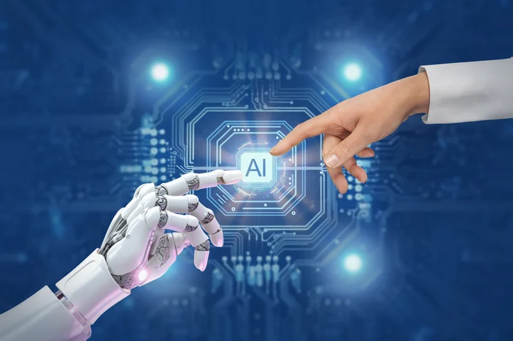 A person is touching a robot 's hand with their finger.