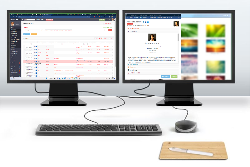Two computer monitors are connected to a keyboard and mouse