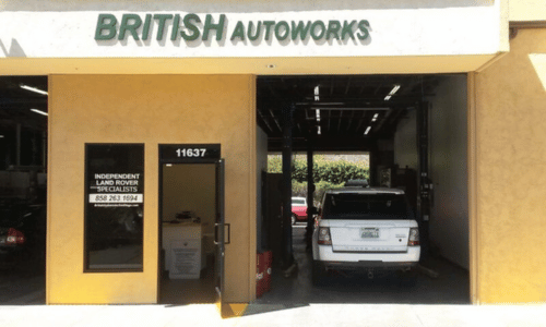British Autoworks storefront with open garage bay and a white SUV inside