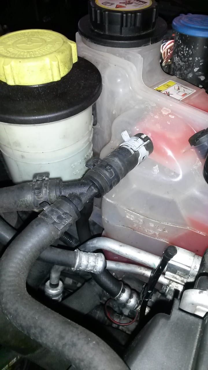 Range Rover Sport coolant expansion tank shows coolant level low.