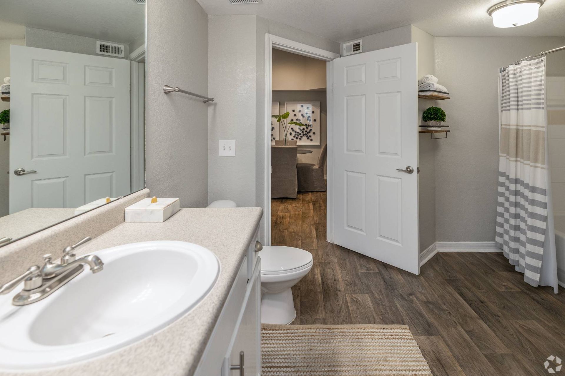 Bathroom in an apartment unit with a sink, toilet, and shower/tub.