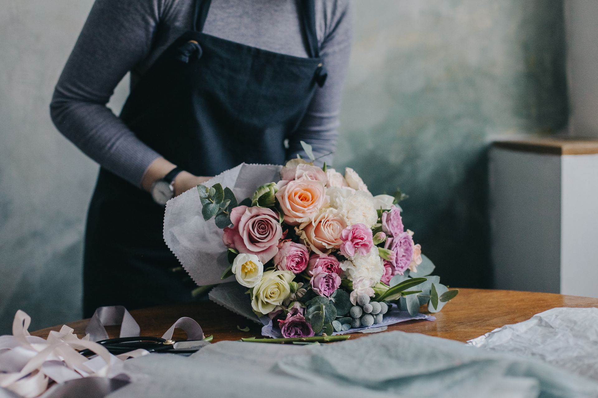A florist is arranging a bouquet.