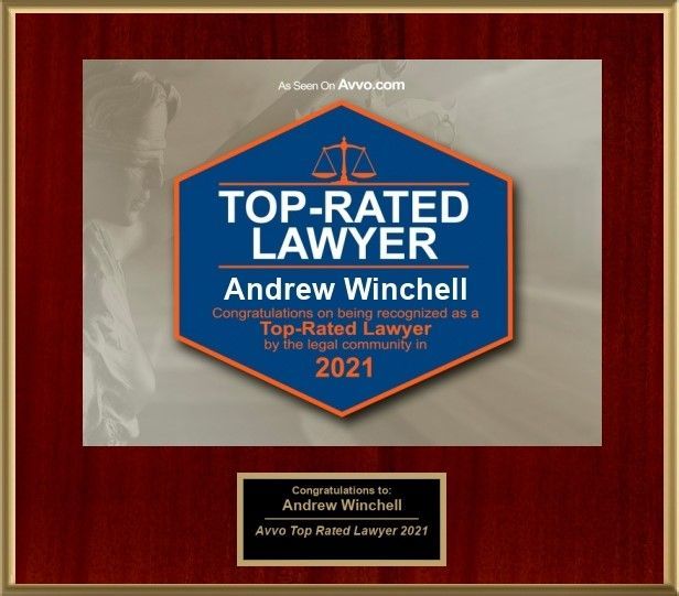 Top-rated lawyer plaque for Andrew Winchell, blue and orange award on red wood background