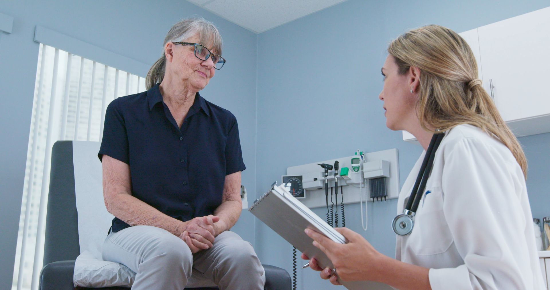 A doctor is speaking with a patient. A doctor is speaking with a patient.