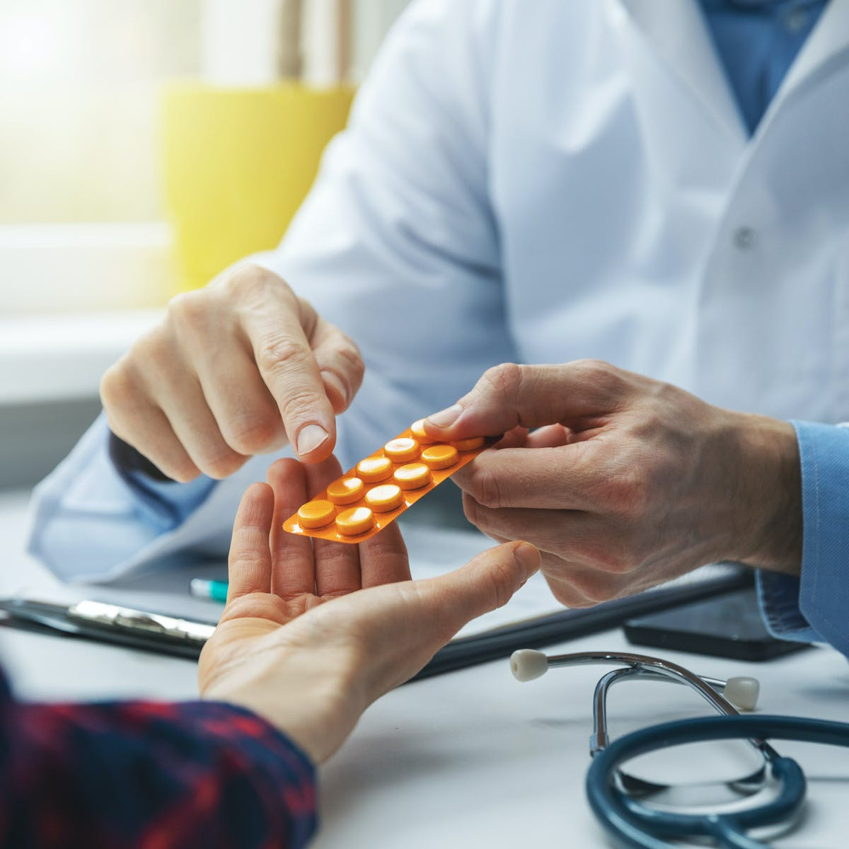 Professional pharmacist providing a private medication therapy management (MTM) consultation to a patient.