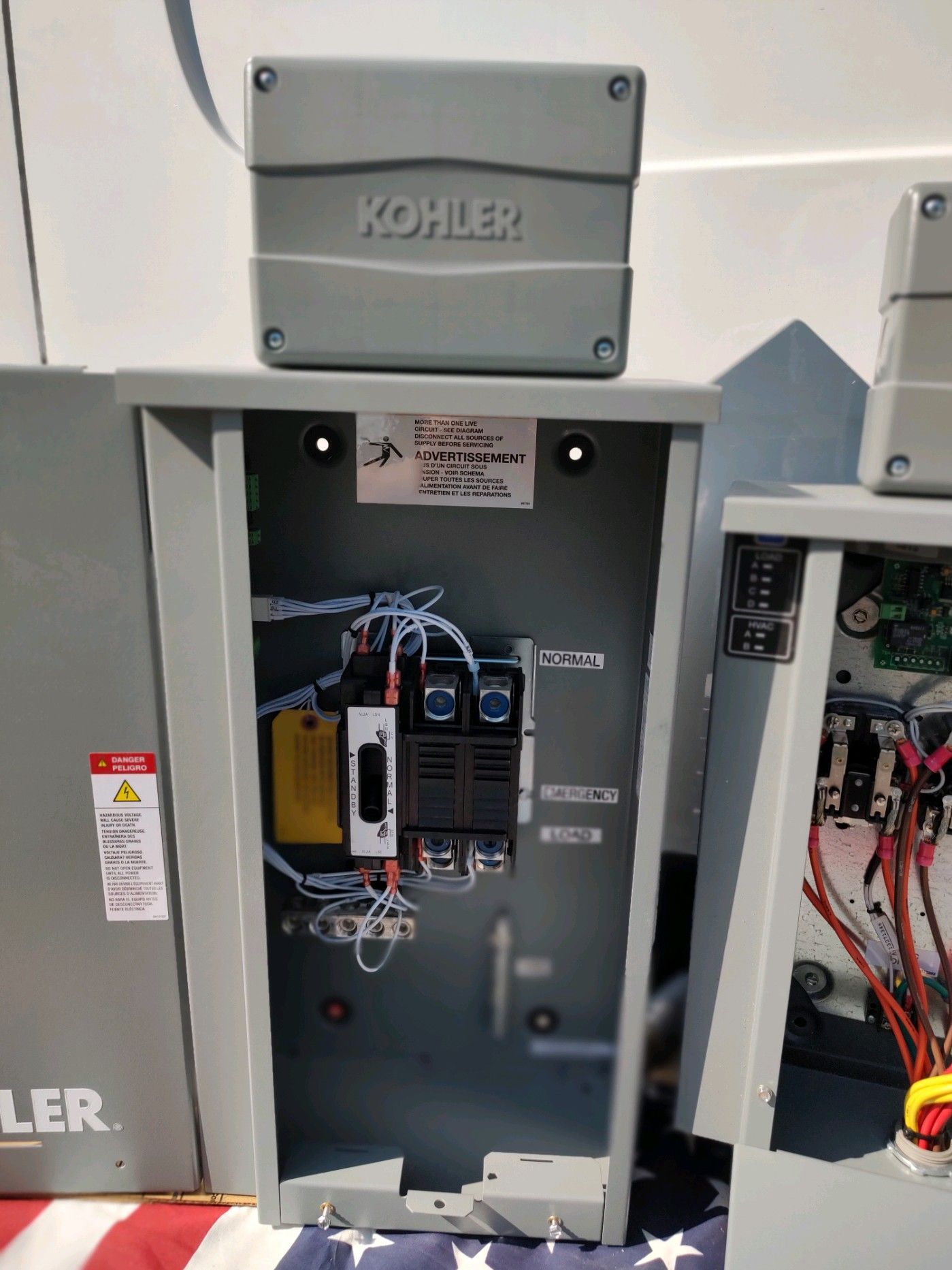 Gray Kohler control box with open panel, wiring, and components.