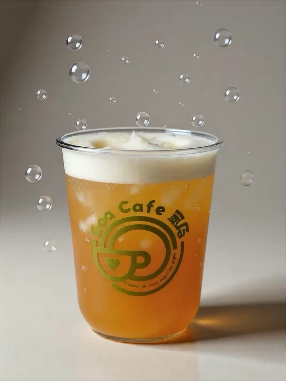 Clear plastic cup of orange beverage with ice and foam, branded logo, against a gray background