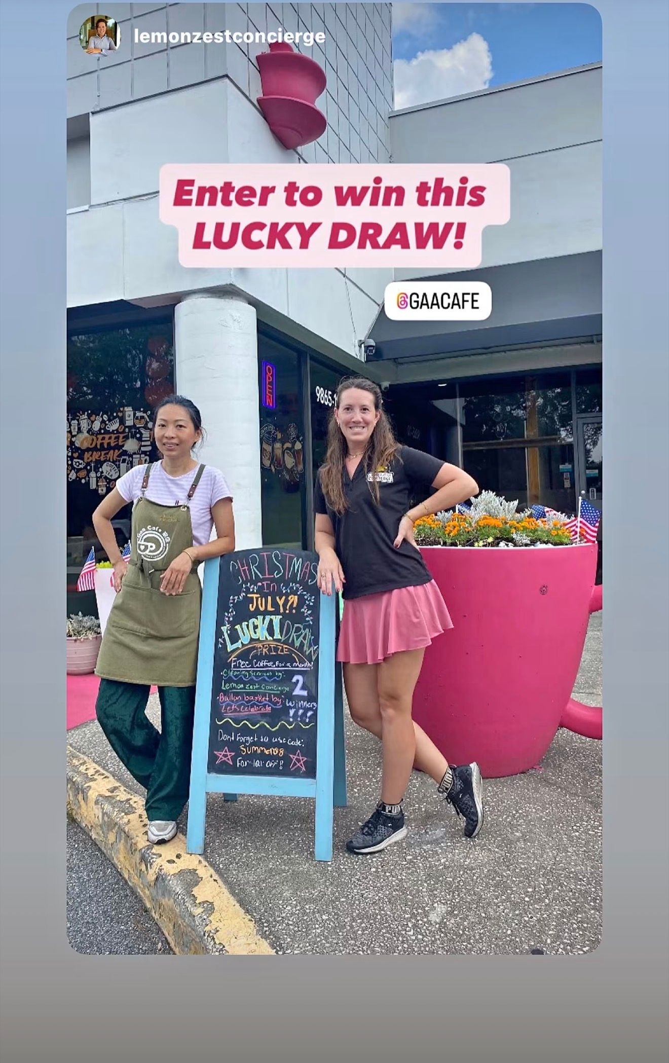 Two women stand by a lucky draw sign outside a shop with a giant pink flower pot.