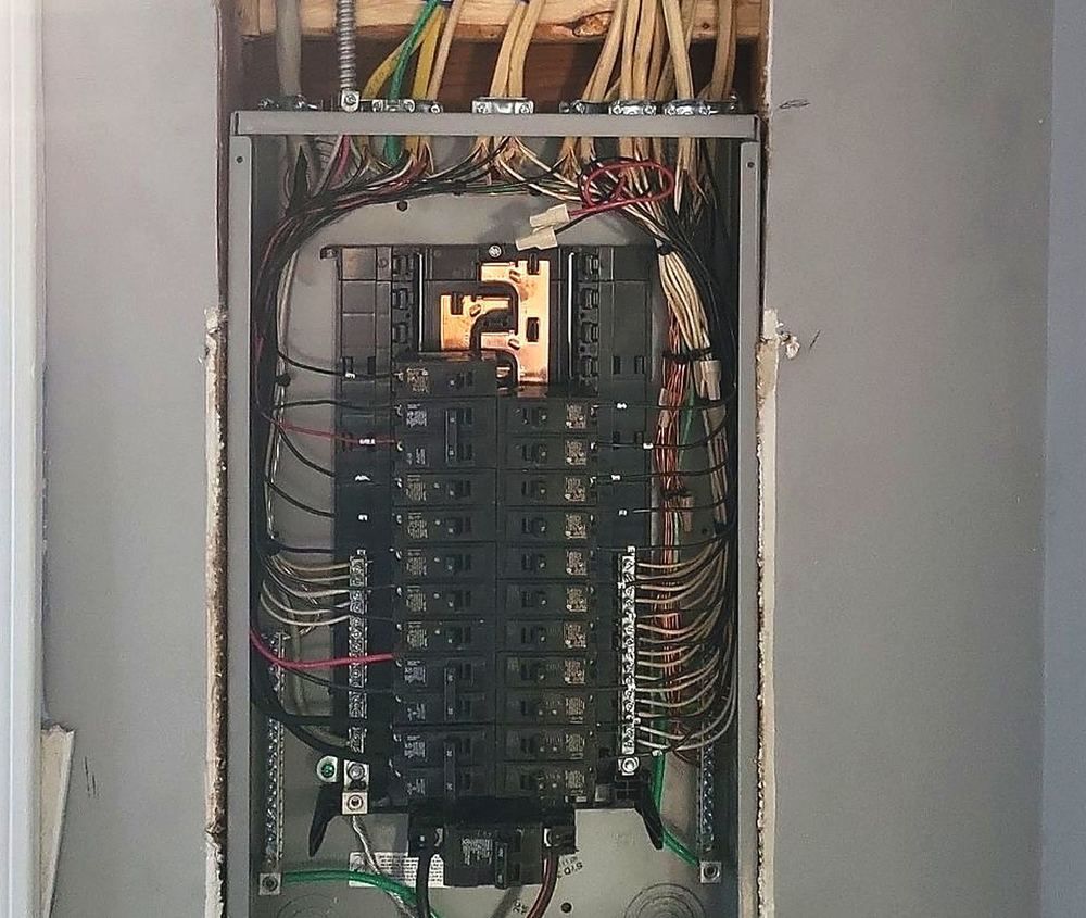 New residential electrical panel with neatly bundled circuit wiring, installed by Lakeview before the drywall goes back