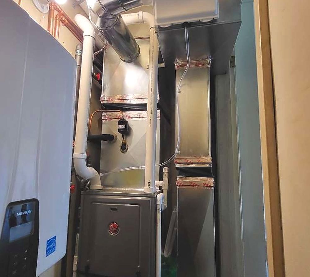 Rheem furnace and Navien tankless water heater installed by Lakeview in a home utility closet