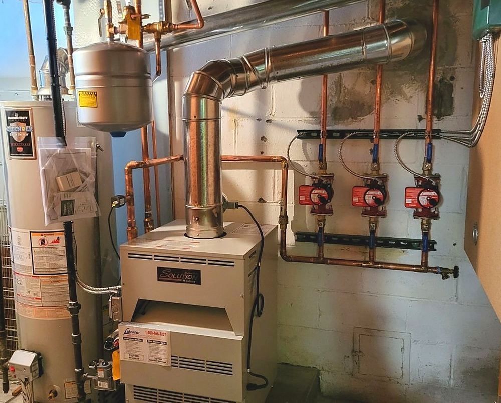 Lochinvar Solution boiler with zone circulator pumps and new venting in a basement, installed by Lakeview
