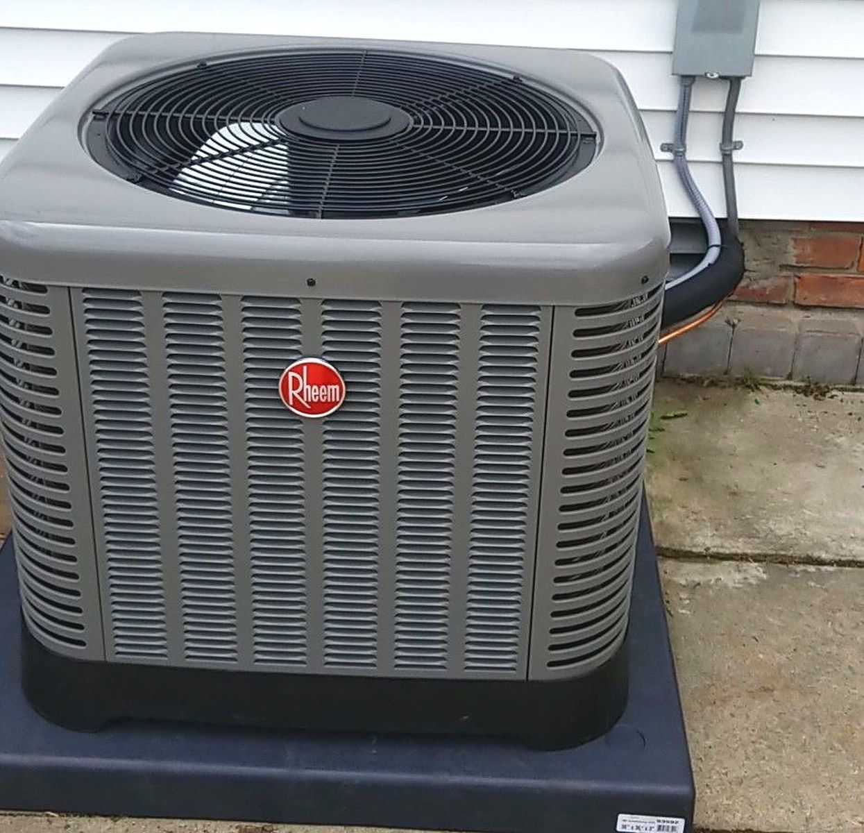 New Rheem condenser on a fresh pad, installed by Lakeview