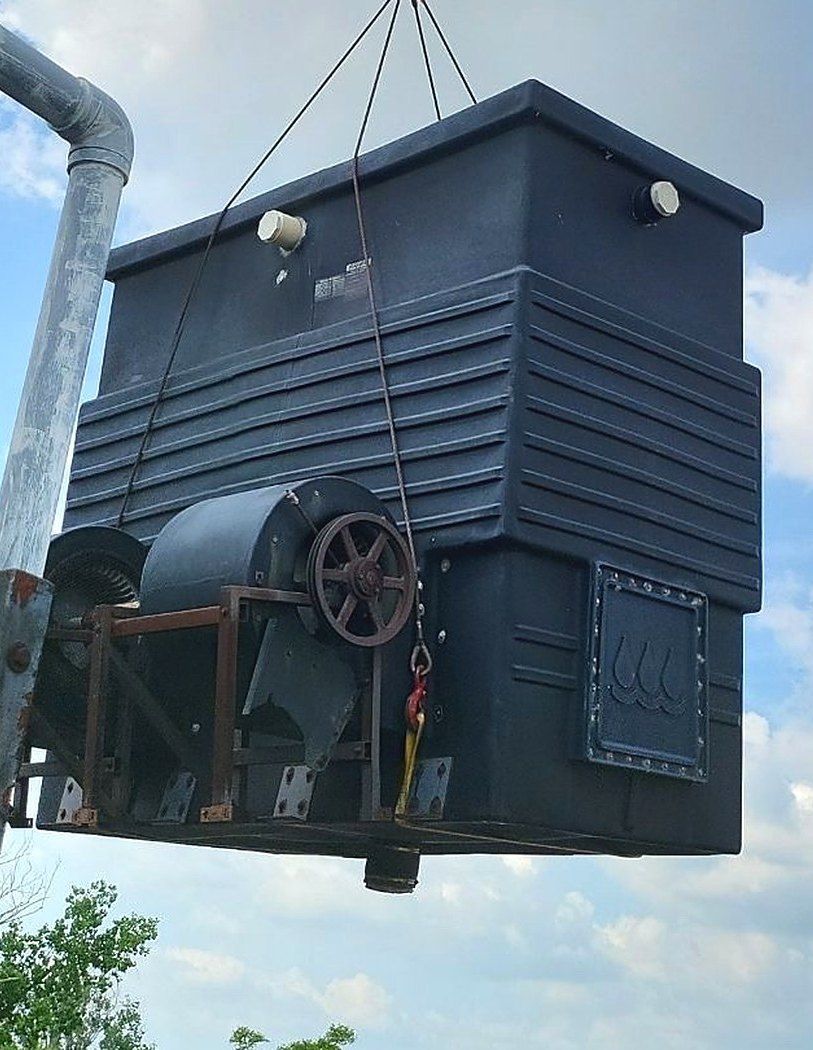 Crane lifting a cooling tower section onto a commercial rooftop on a Lakeview job