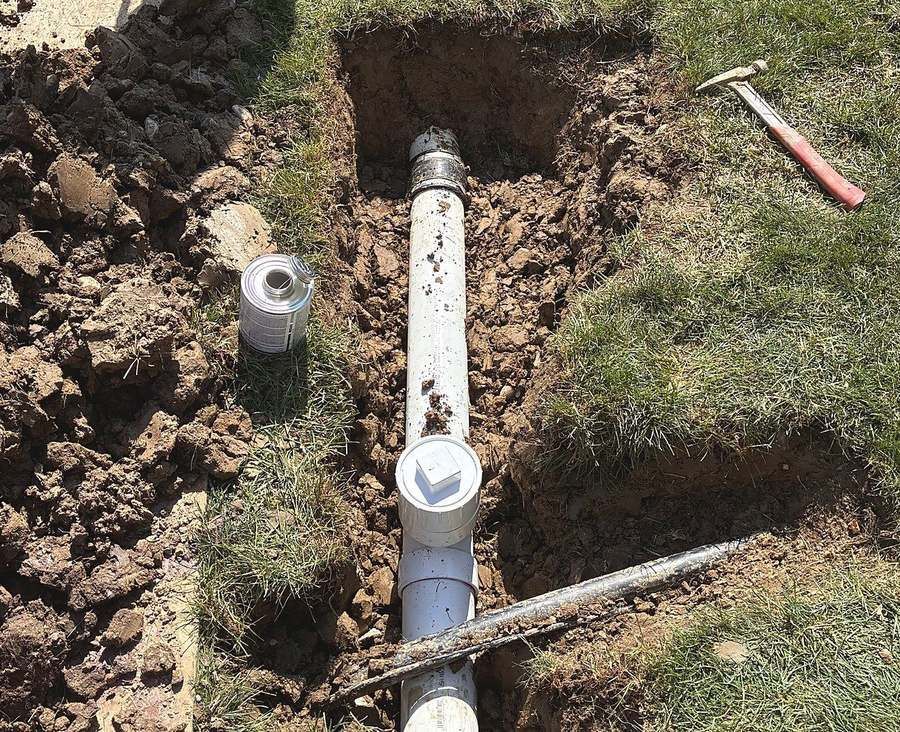 Repaired sewer line with a new PVC section, rubber couplings and a cleanout, installed by Lakeview