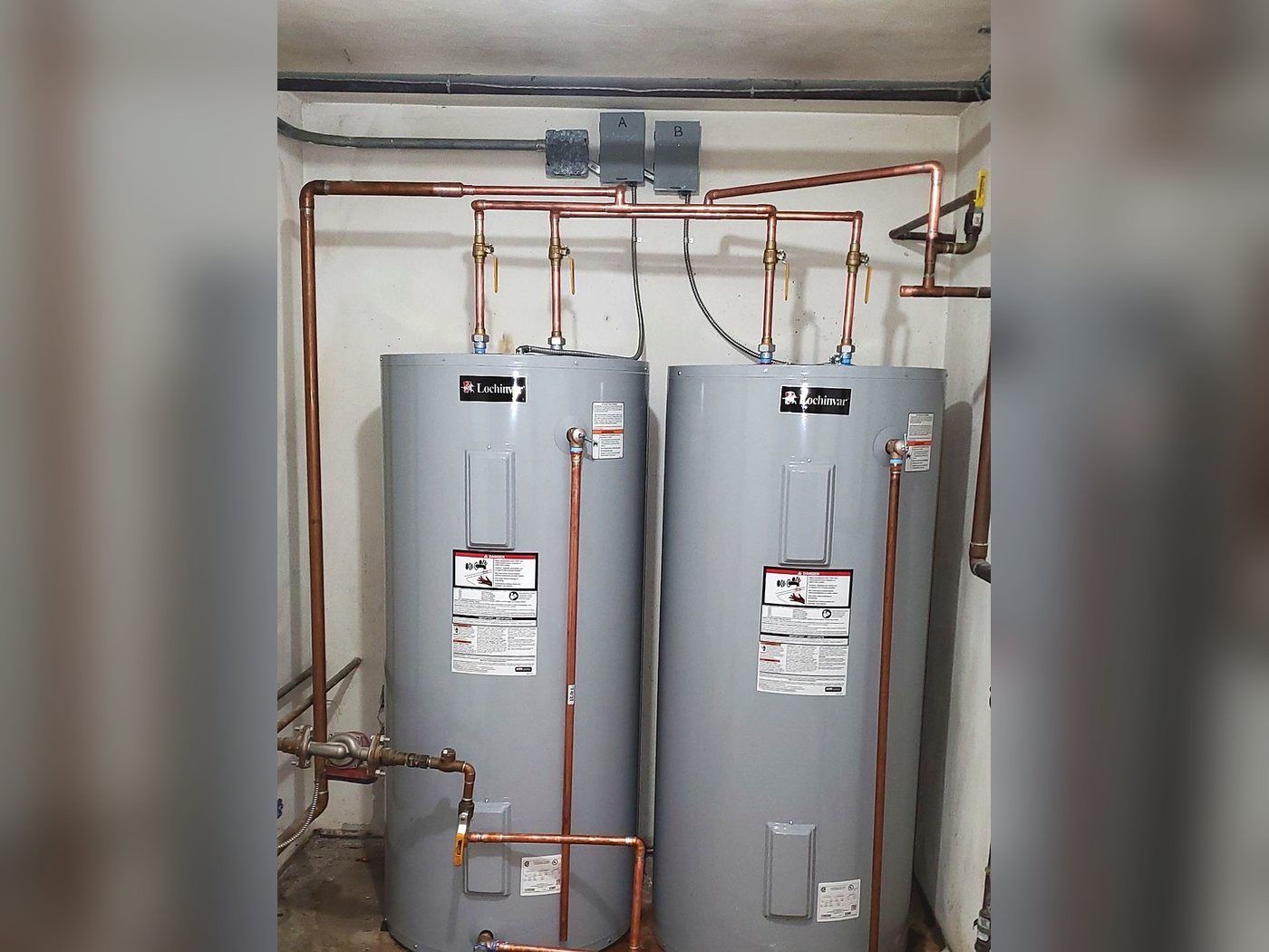 Two Lochinvar electric water heaters piped in parallel with copper supply lines, installed by Lakeview