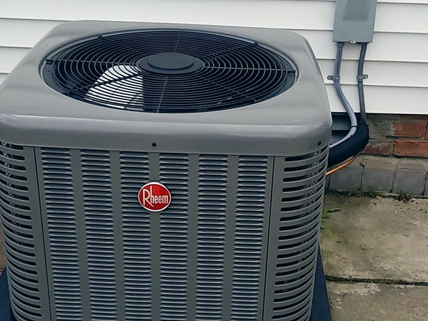 Rheem air conditioning condenser installed beside a home by Lakeview Plumbing, Heating, Cooling & Electrical in Warren, MI